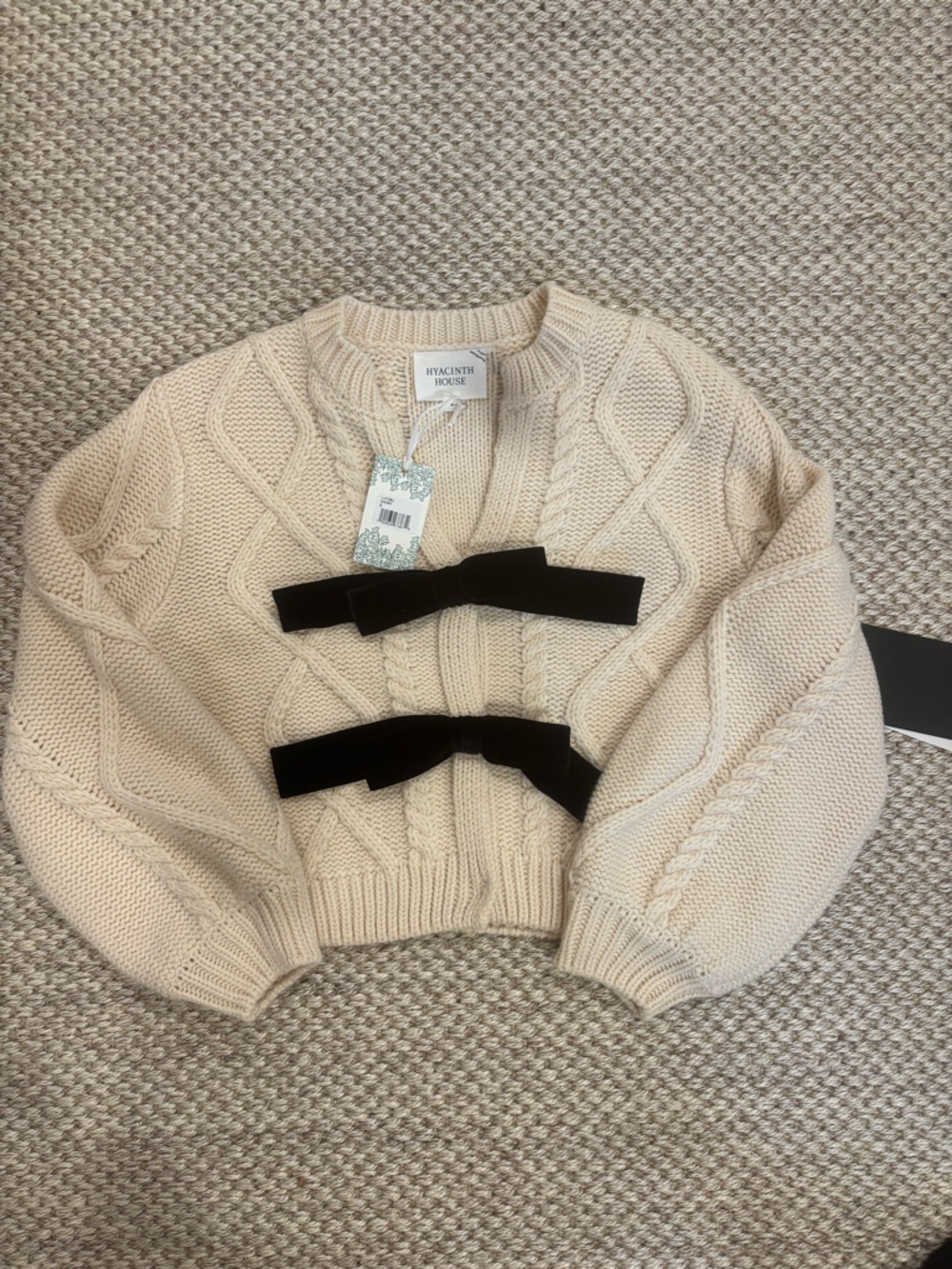 Hyacinth House Cream Cable-Knit Off-the-Shoulder Sweater with Black Velvet Bows